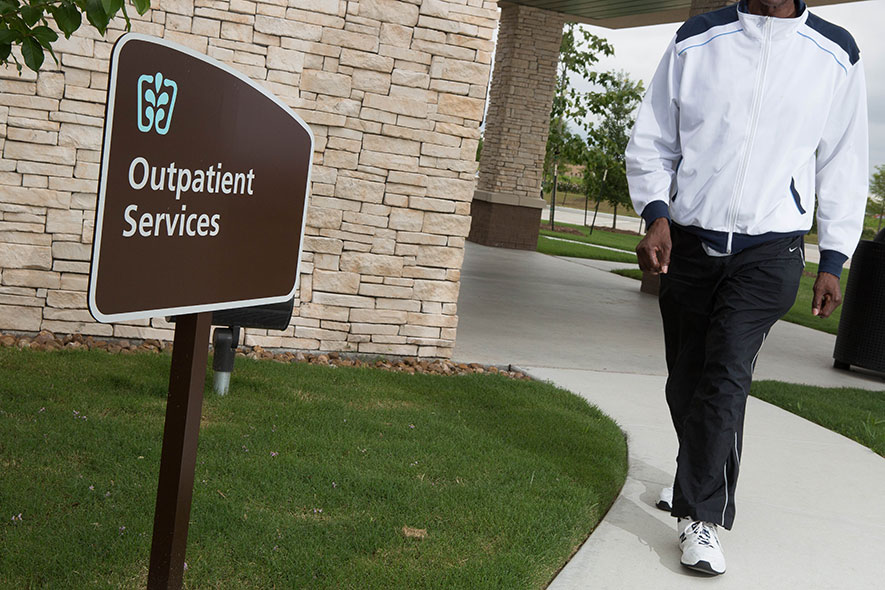 outpatient services sign man walking